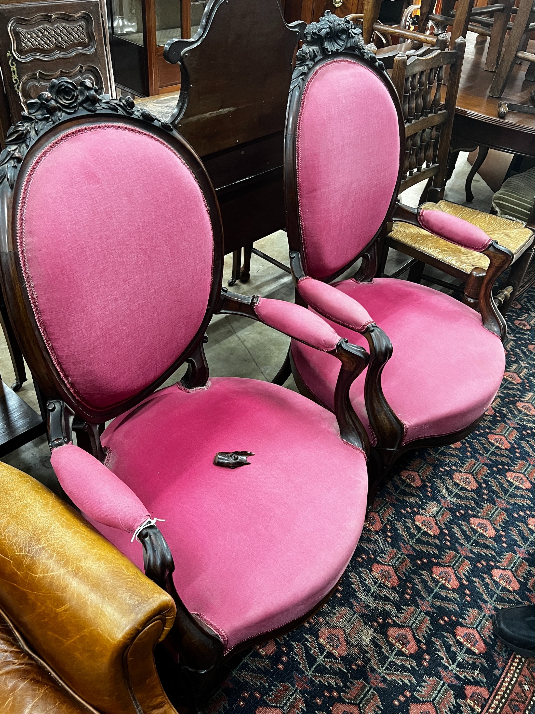 A near pair of 19th century French rosewood upholstered armchairs, larger width 61cm, depth 56cm, height 108cm